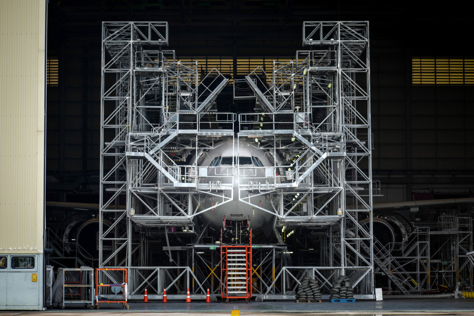 Jet airplane surrounded by scaffolding